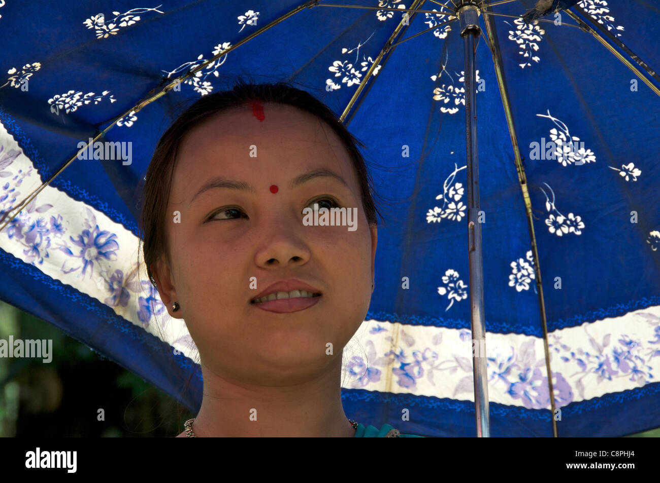 Portrait pretty girl with blue umbrella Kurseong West Bengal India Stock Photo