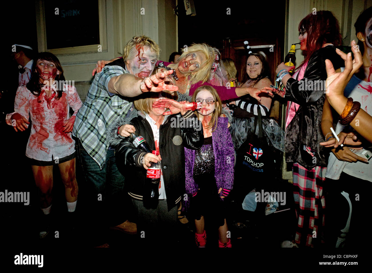 A family of Zombies posing outside a pub during a Zombie Walk and pub crawl for Halloween Piccadilly Circus London 2011. Stock Photo