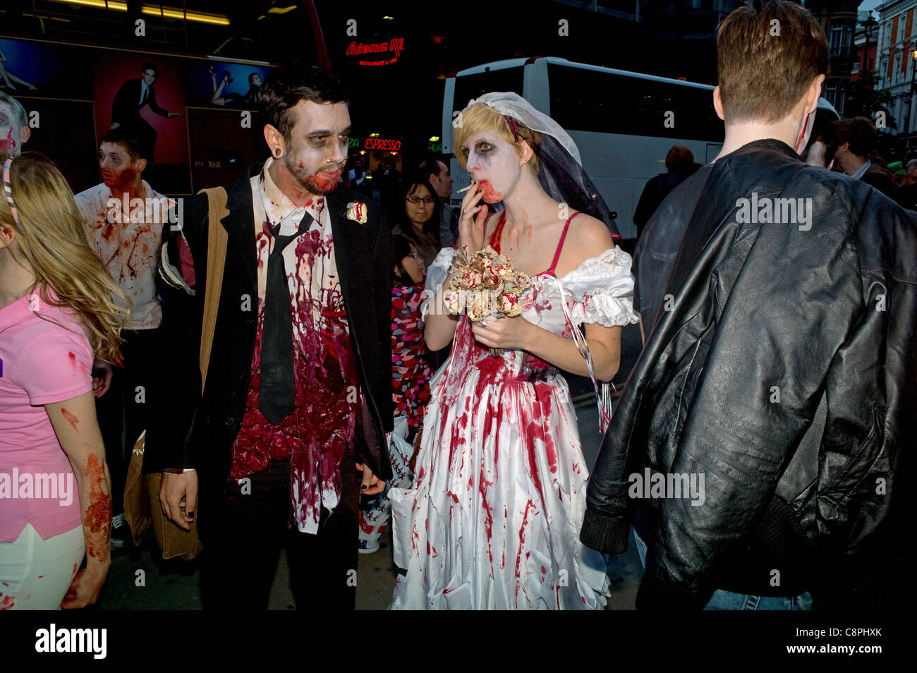 A Zombie Bride And Groom Posing During A Halloween Pub Crawl Stock