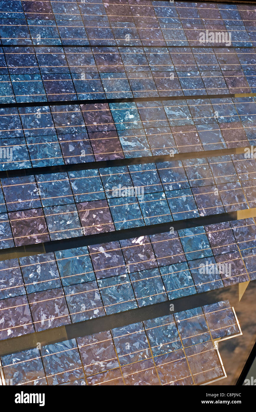 Detail shot showing polycrystalline photovoltaic cells mounted within a solar glass building facade. Stock Photo