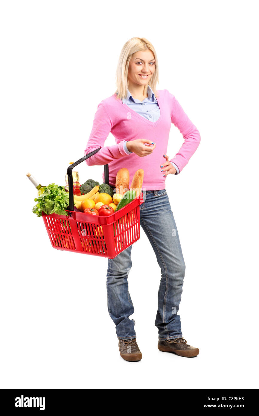 Full length portrait of a young woman holding a shopping basket Stock ...