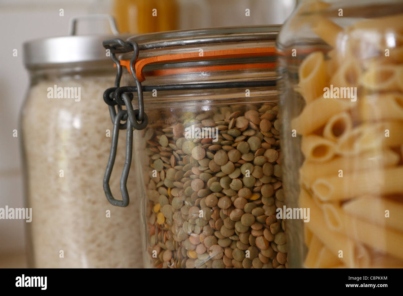 Green lentils in glass kitchen storage jar Stock Photo
