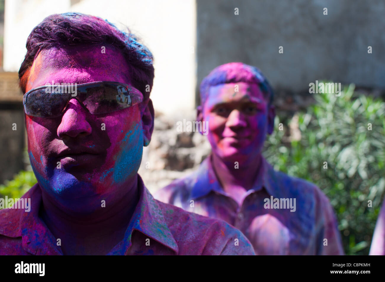 Two men pose for the camera after celebrating Holi, the Hindu festival of light. Rajasthan, India. Stock Photo