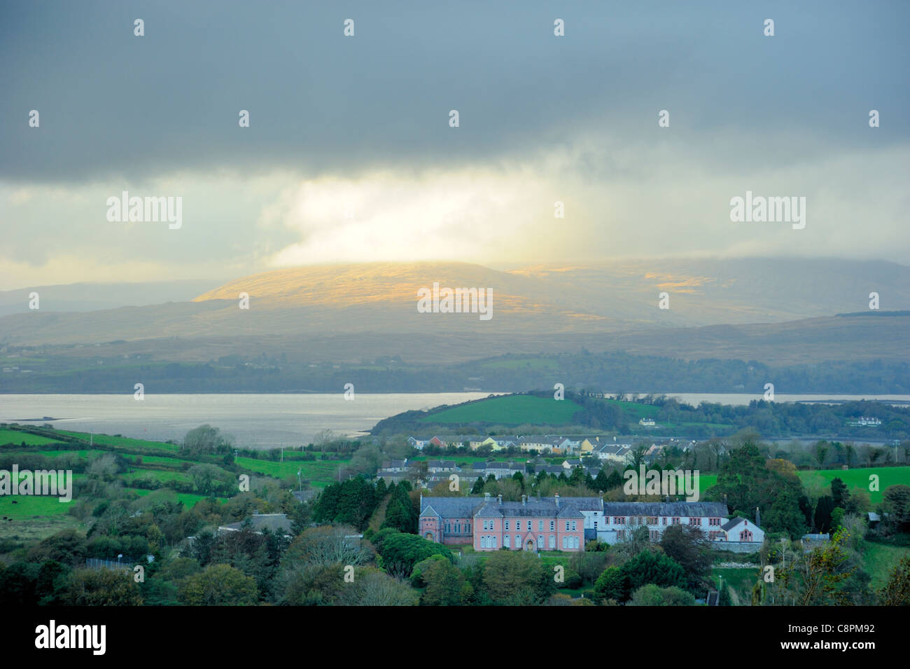A break in the clouds over the Caha mountains from Bantry on a dull day Stock Photo