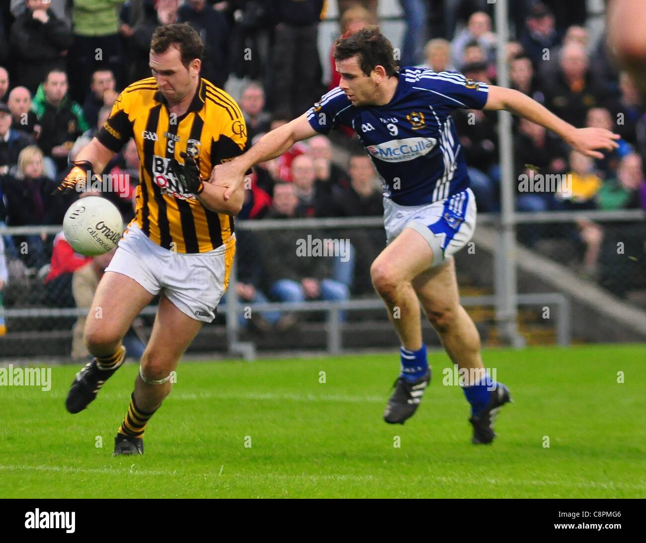 Crossmaglen's David McKenna is tackled by Saint Gall's Sean Burke Reigning Ulster and All Ireland Gaelic Football Champions Crossmaglen Rangers  defeat St Galls in the Ulster Club Football Quarter Final with a score line of 3-09 to 2-06 in Casement Park, Belfast on Sunday 30 October 2011 Stock Photo