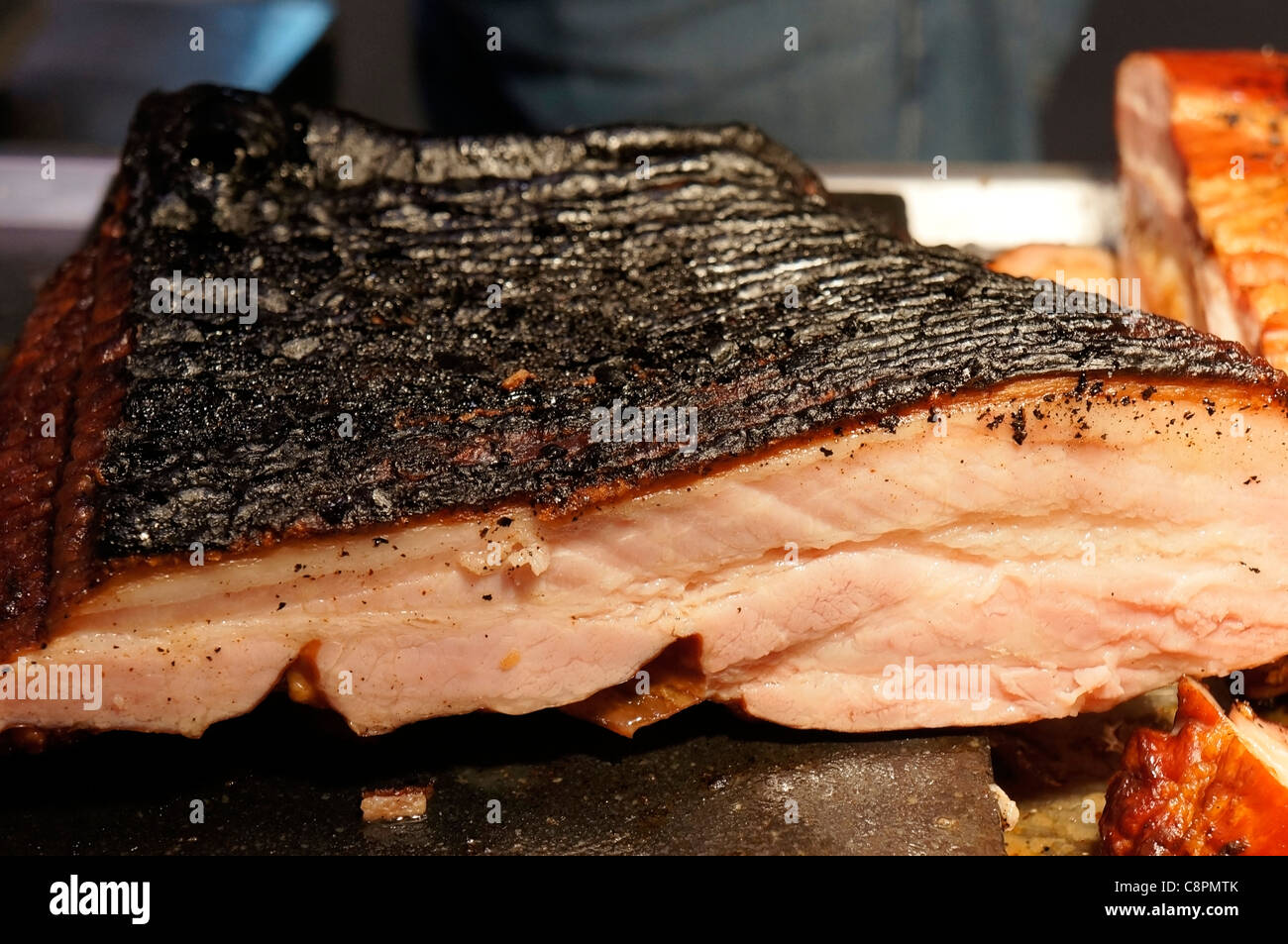 Roast Ham, Sliced Charred Bacon at a Deli Stock Photo