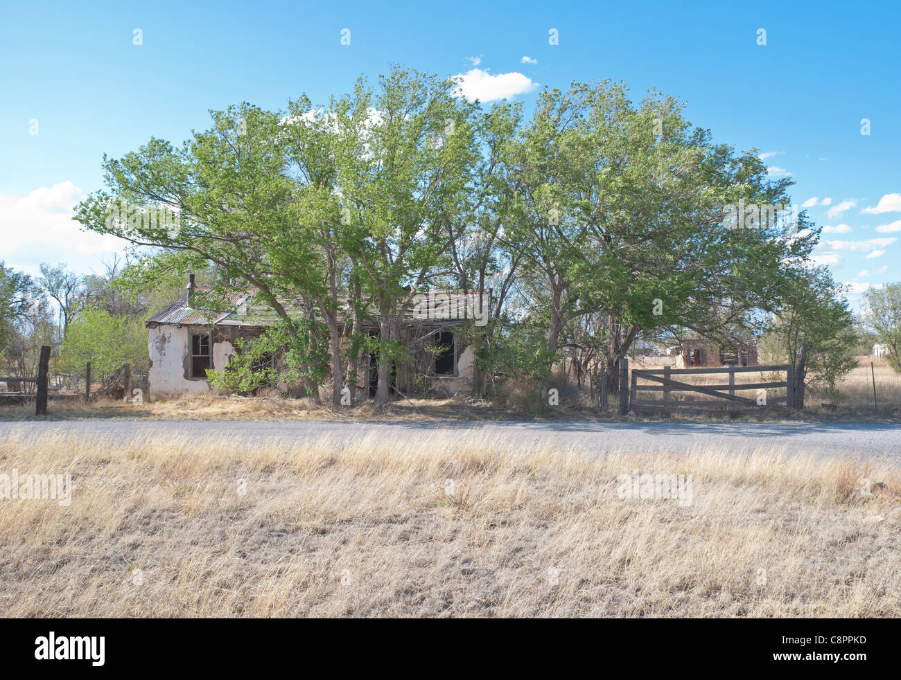 One of many abandoned homes in Encino looks picturesque against the blue New Mexico sky. Stock Photo