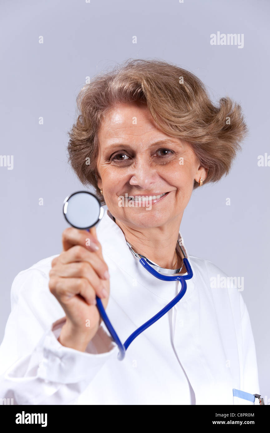 Happy senior doctor smiling (isolated on gray Stock Photo - Alamy