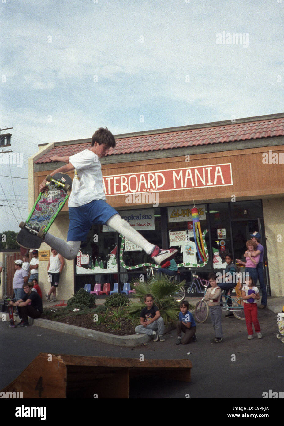 Tom Knox catches air from a jump ramp during a skateboarding