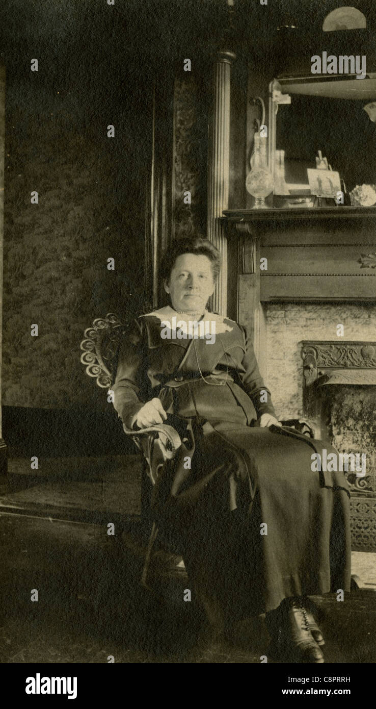 Circa 1890 photograph of an elderly woman in her home's Victorian parlor. Stock Photo