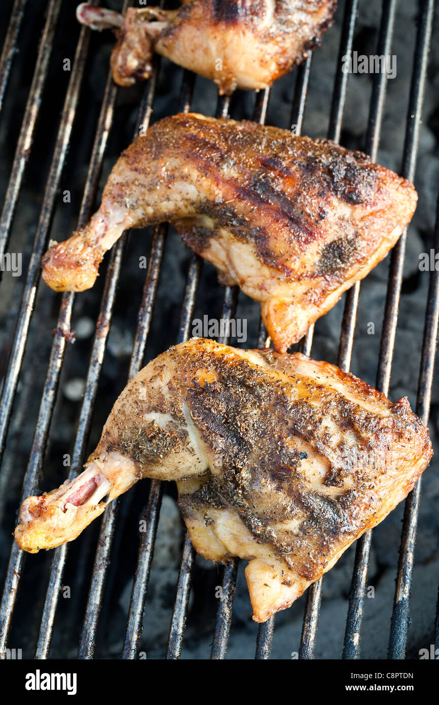 Chicken cooking on a grill Stock Photo Alamy