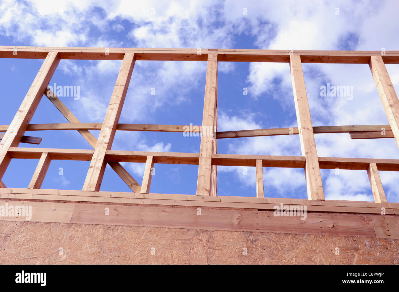 The newly constructed wooden frame house fragment. Construction industry. Stock Photo