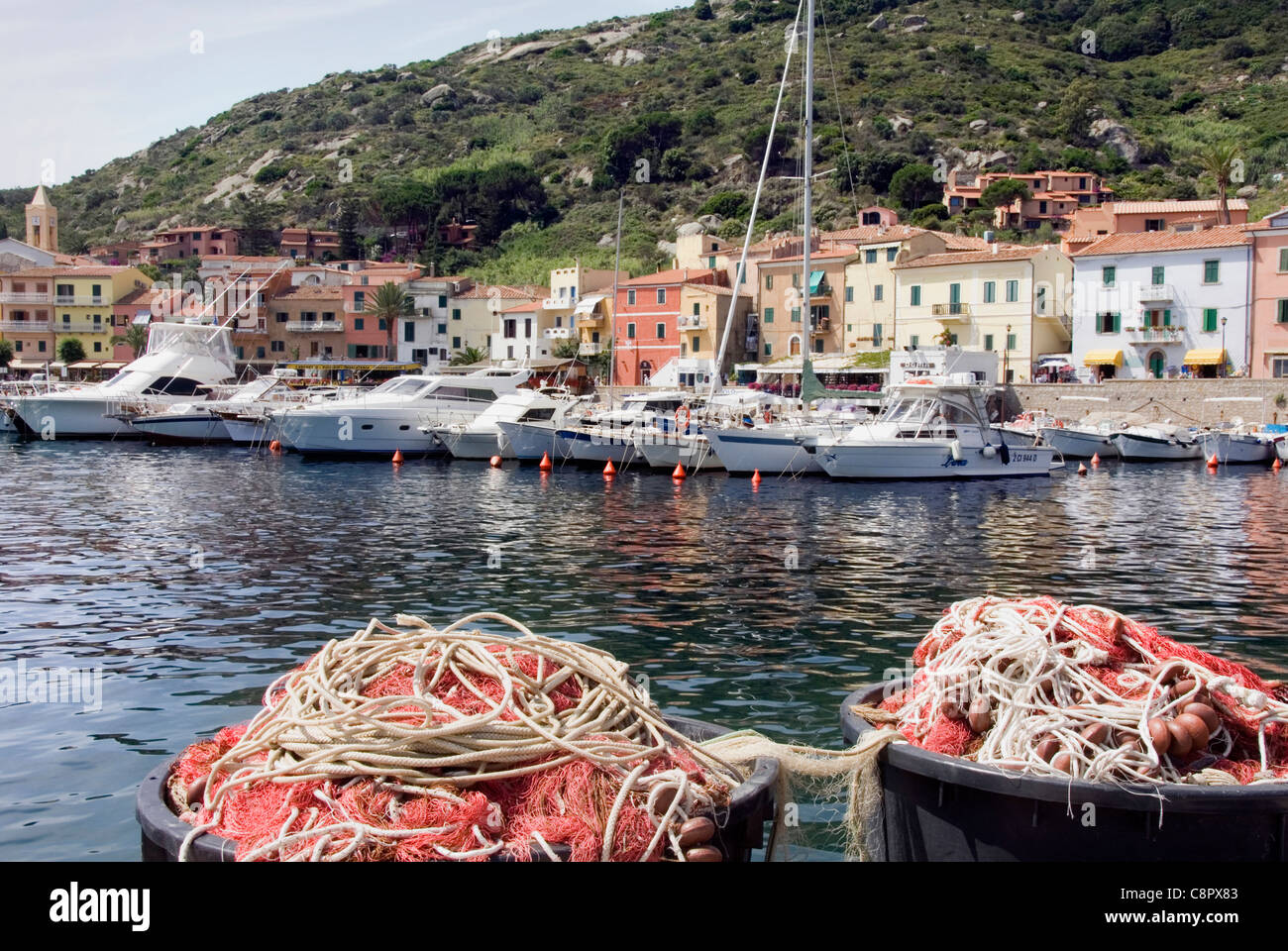 Italy, Isola del Giglio, fishing nets and houses of Giglio Porto Stock Photo