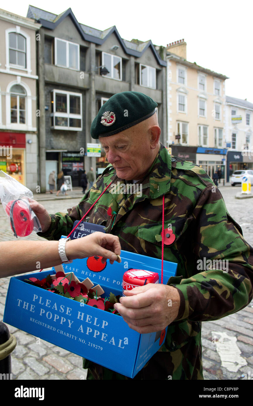 An old serviceman selling poppies in the main street of truro in cornwall, uk Stock Photo