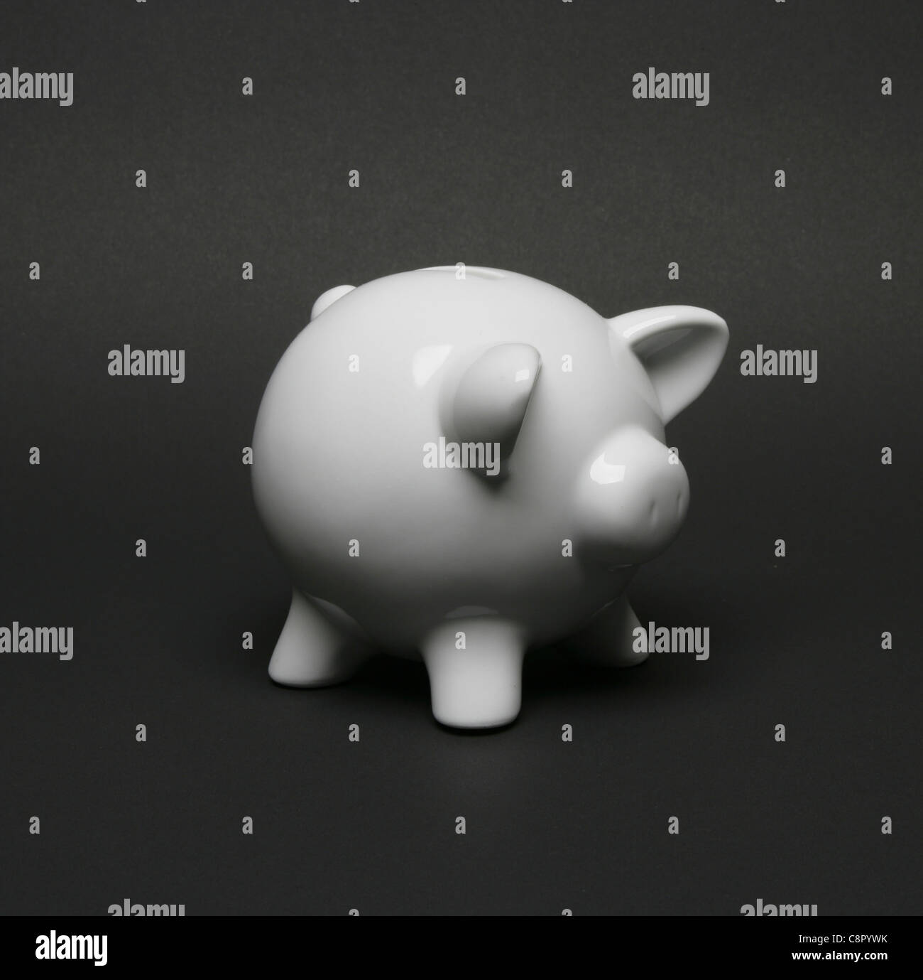 white piggy-bank against black background Stock Photo - Alamy