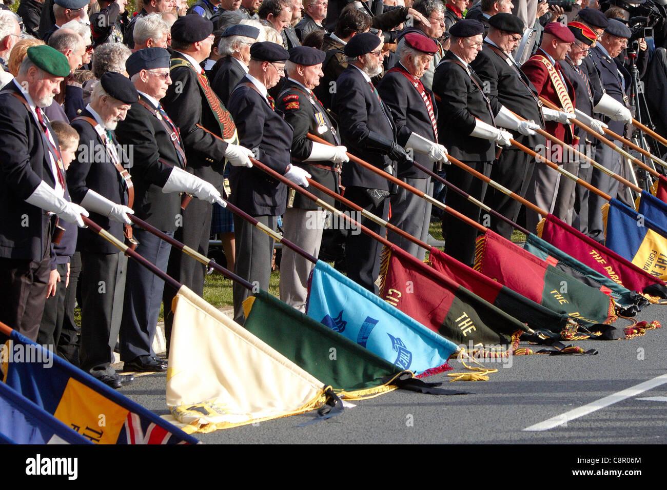 Standard bearers lower their flags as the cortege passes in Carterton