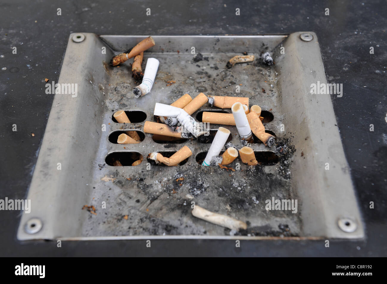 Ashtray in the car full of cigarette ends and ash Stock Photo