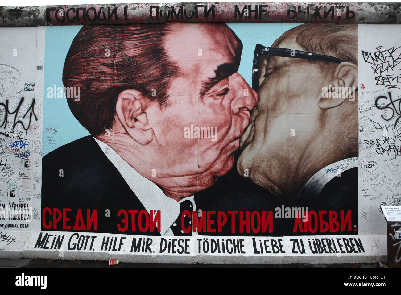Leonid Brezhnev and Erich Honecker’s kiss pictured on the Berlin Wall in East Side Gallery in Berlin, Germany. Stock Photo