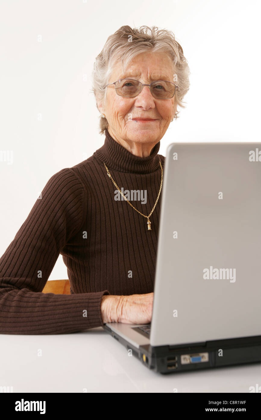 A happy old lady using a laptop Stock Photo - Alamy