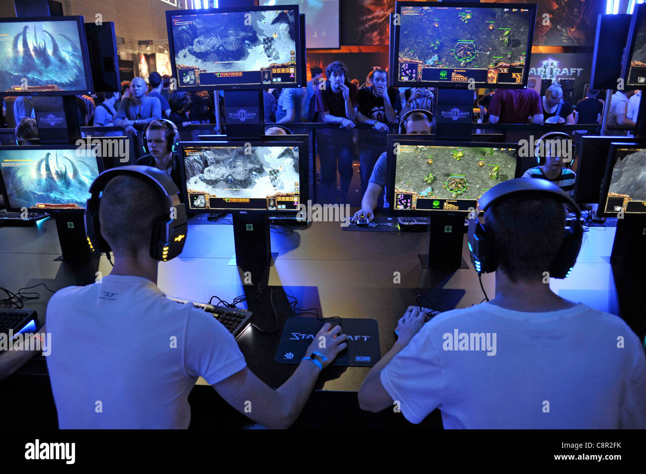 teenagers play the latest version of 'starcraft' at the gamescom convention in Cologne, Germany Stock Photo