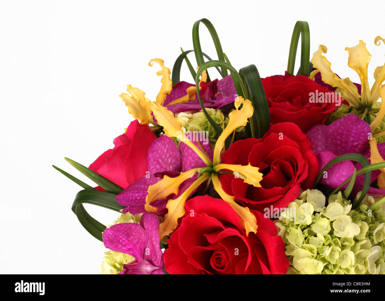 A close-up of a colorful bouquet of flowers. Red roses, cream hydrangea, yellow orchid [Laelia], purple orchid [Vanda] Stock Photo