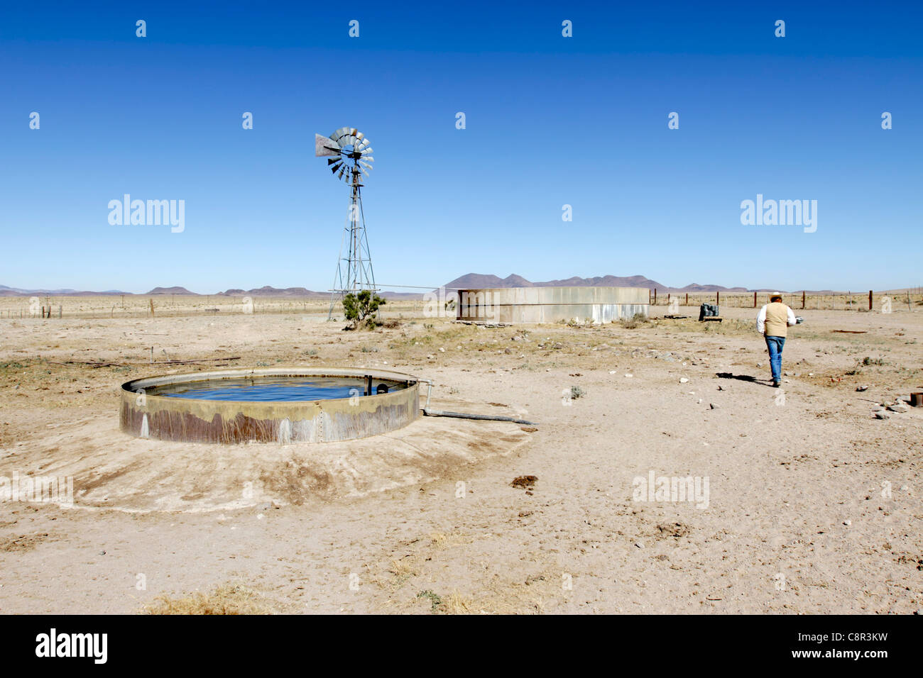 Rancher inspecting water supply in a cattle pen on a ranch in West Texas. Stock Photo