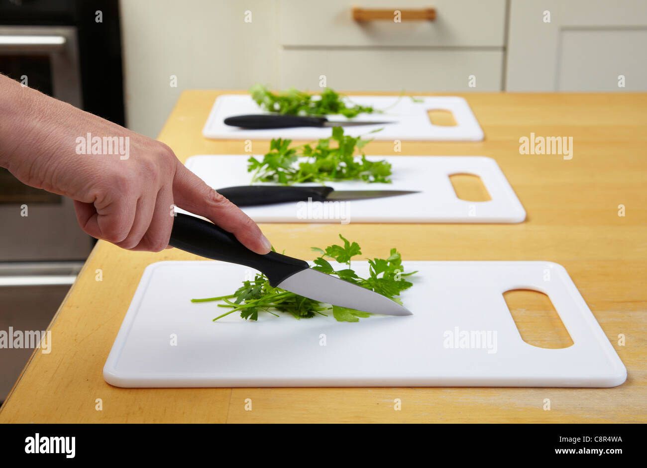Green herbs on chopping board with kitchen knife. Ready for chopping in