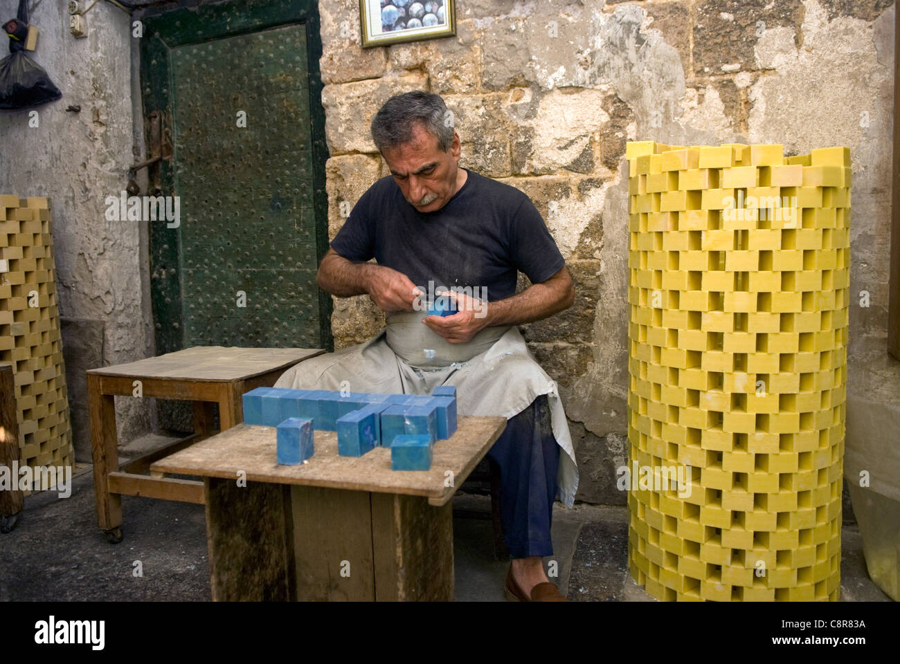 Traditional soap maker at work in his souk, old city, Tripoli