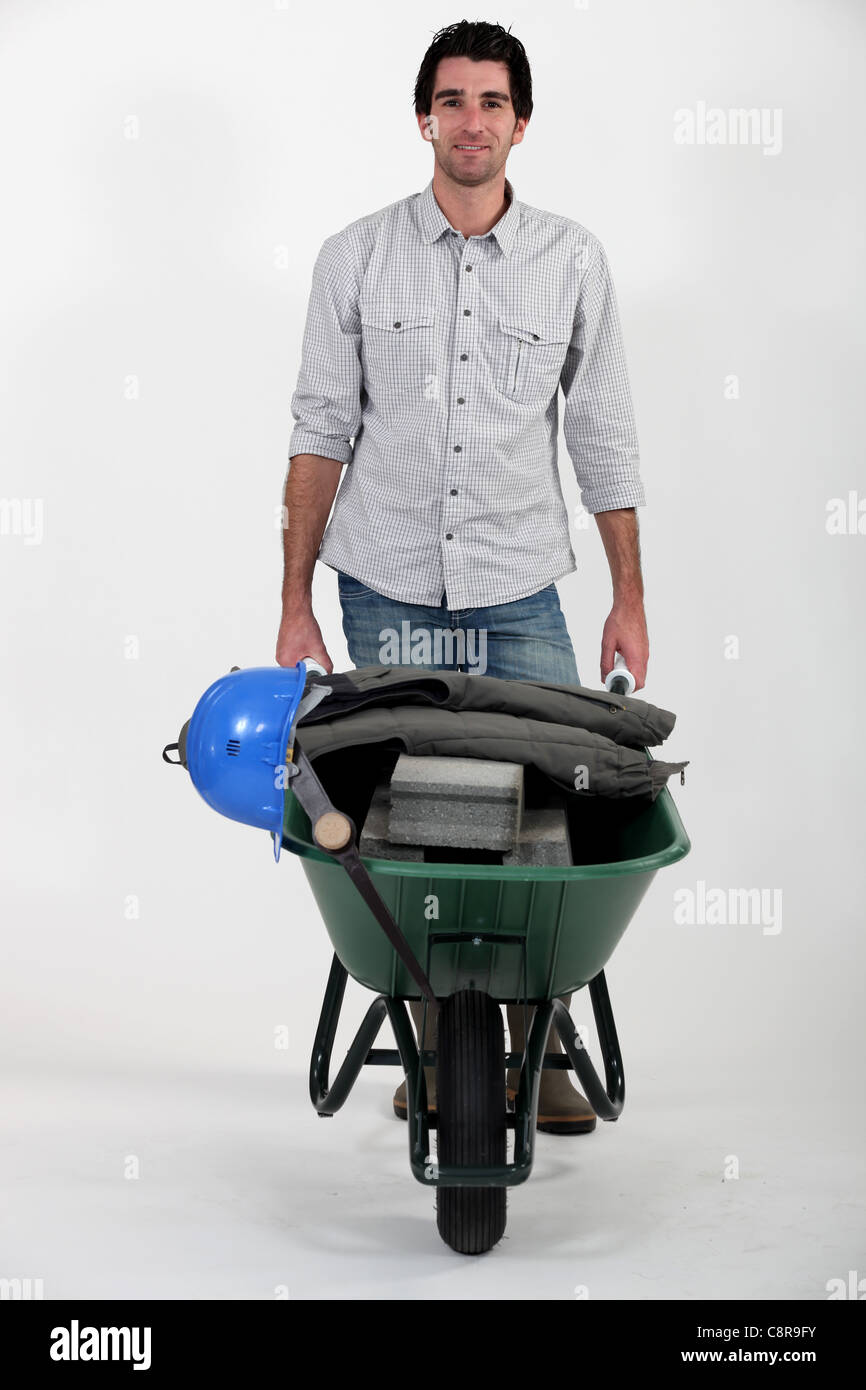 craftsman pushing a wheelbarrow Stock Photo - Alamy