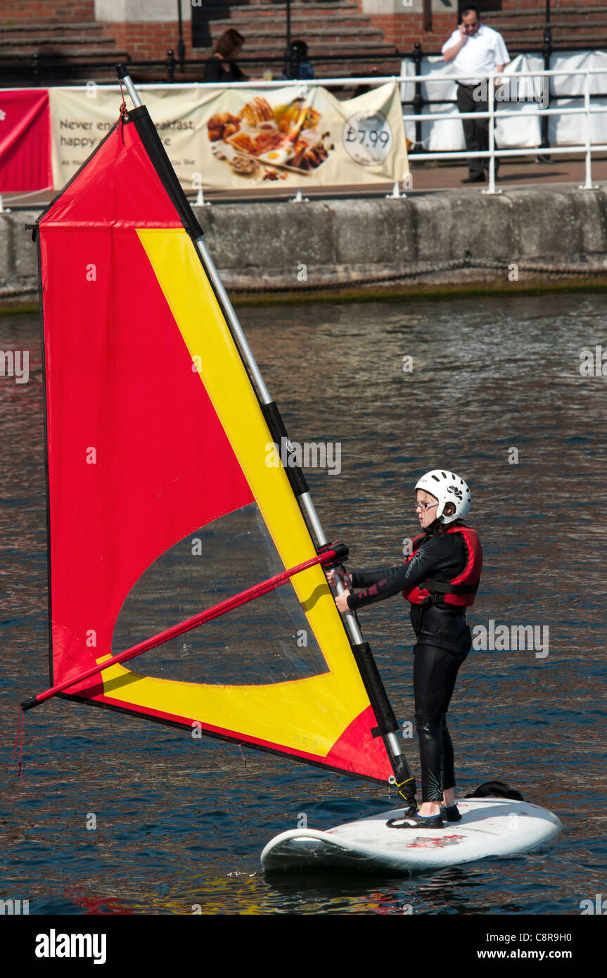 A child practicing windsurfing at the Watersports Centre, Salford Quays, Manchester, England, UK Stock Photo