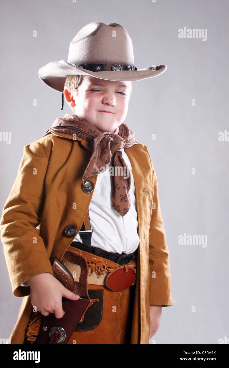 A young cowboy child with a mean face Stock Photo