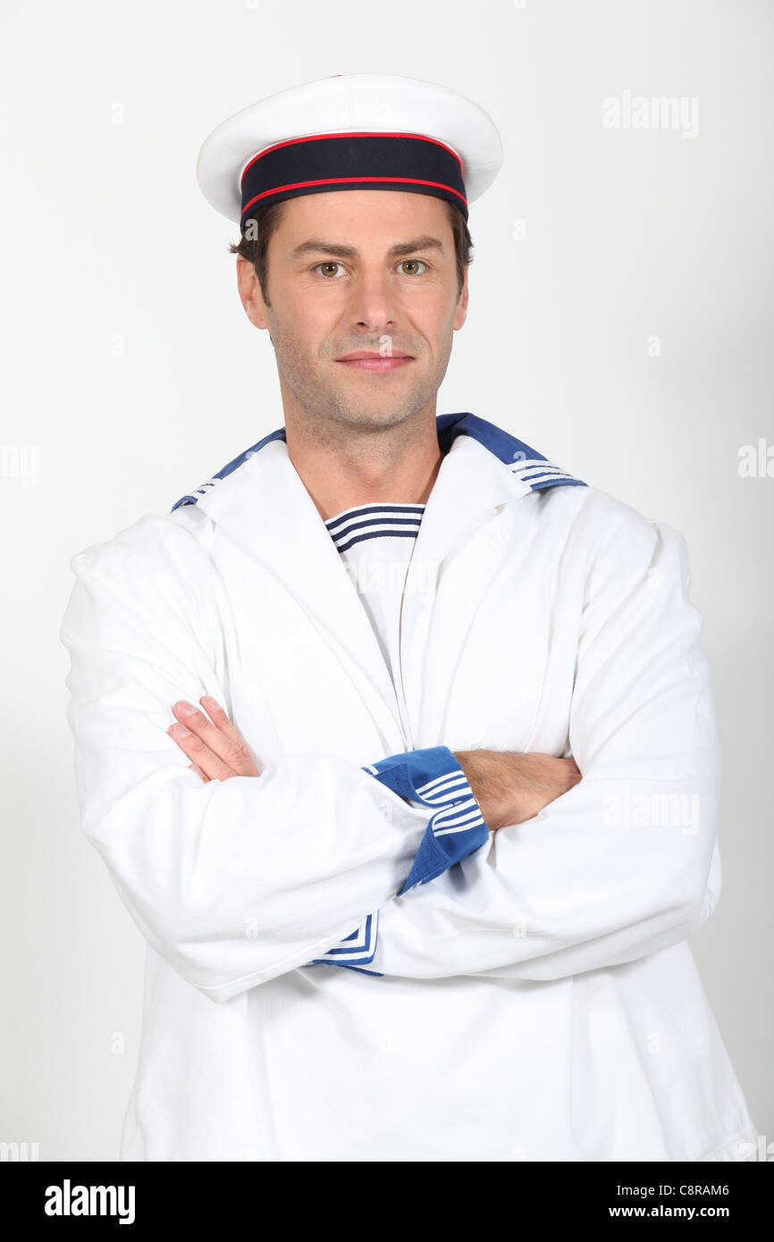 Man in a sailor's costume standing with his arms folded Stock Photo