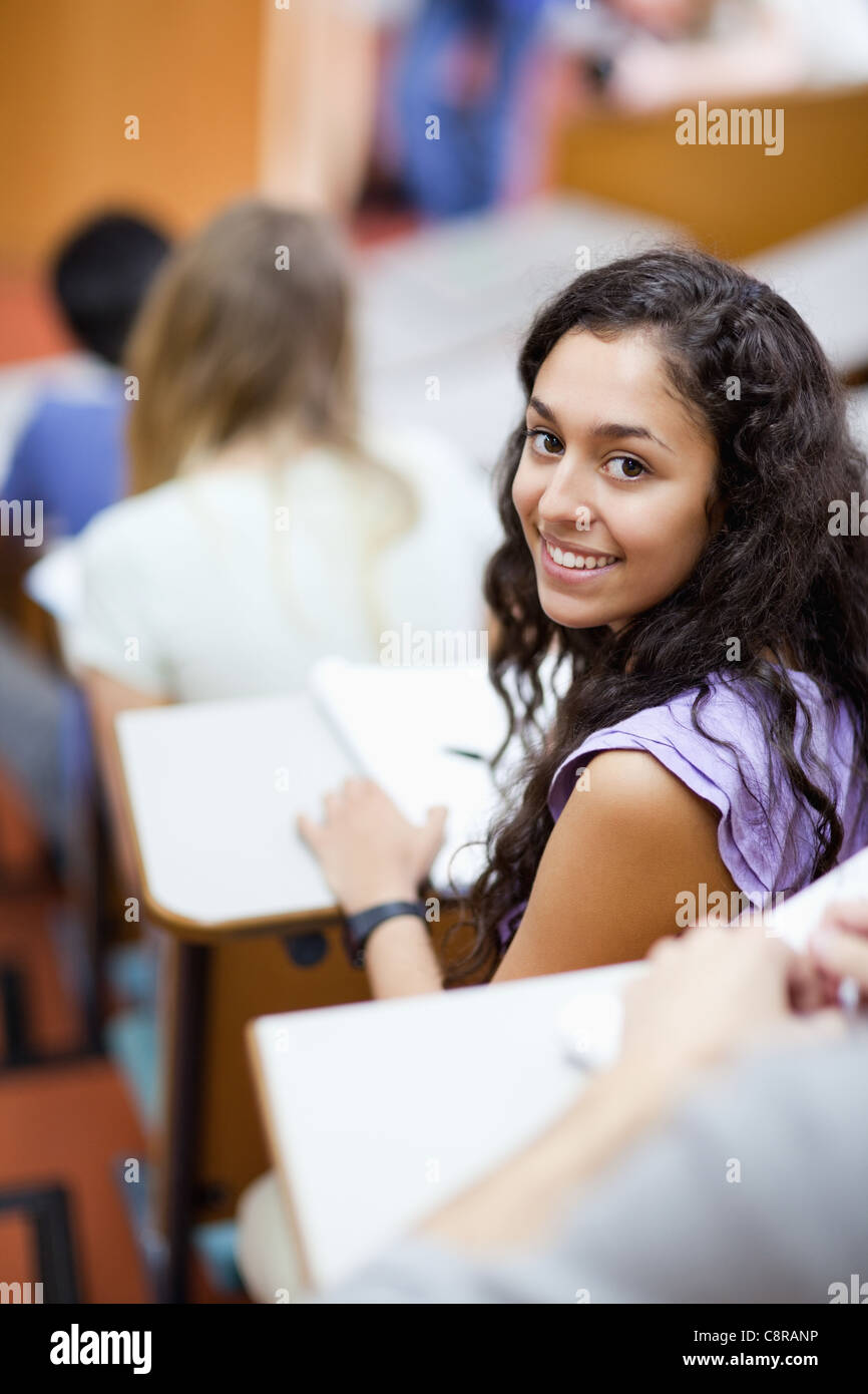 Portrait of a smiling student being distracted Stock Photo