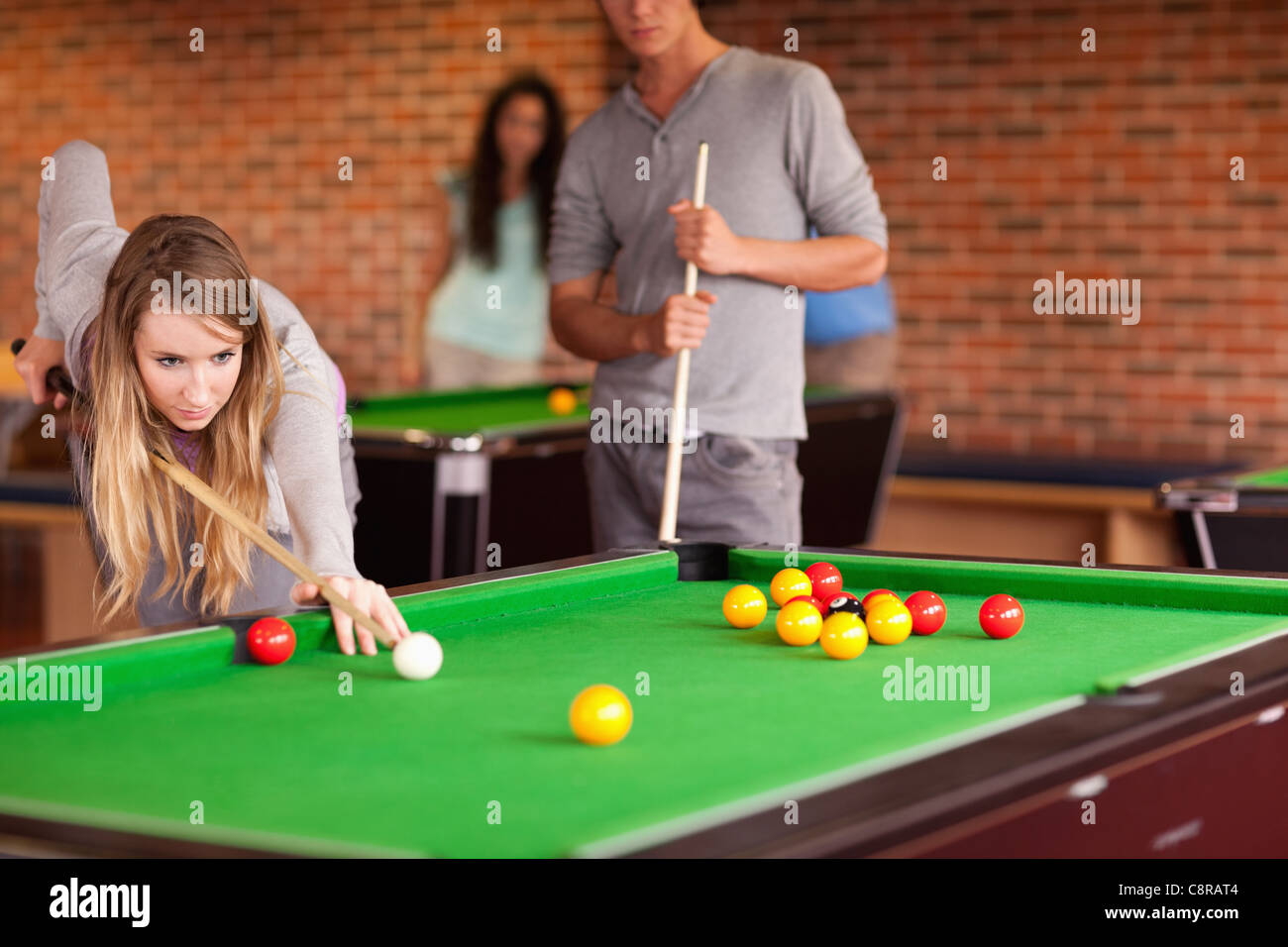 Friends playing snooker Stock Photo - Alamy