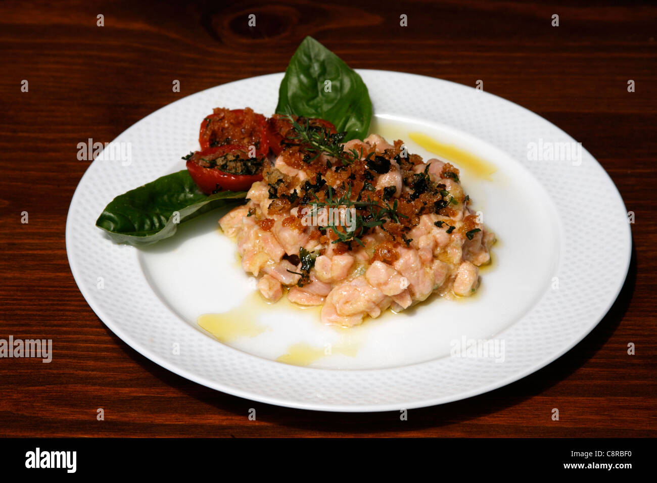 Salmon with stuffed tomatoes Stock Photo