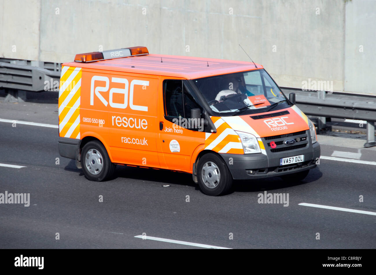 RAC automotive services company breakdown rescue van displaying remembrance  poppy driving along M25 motorway Essex England UK Stock Photo - Alamy