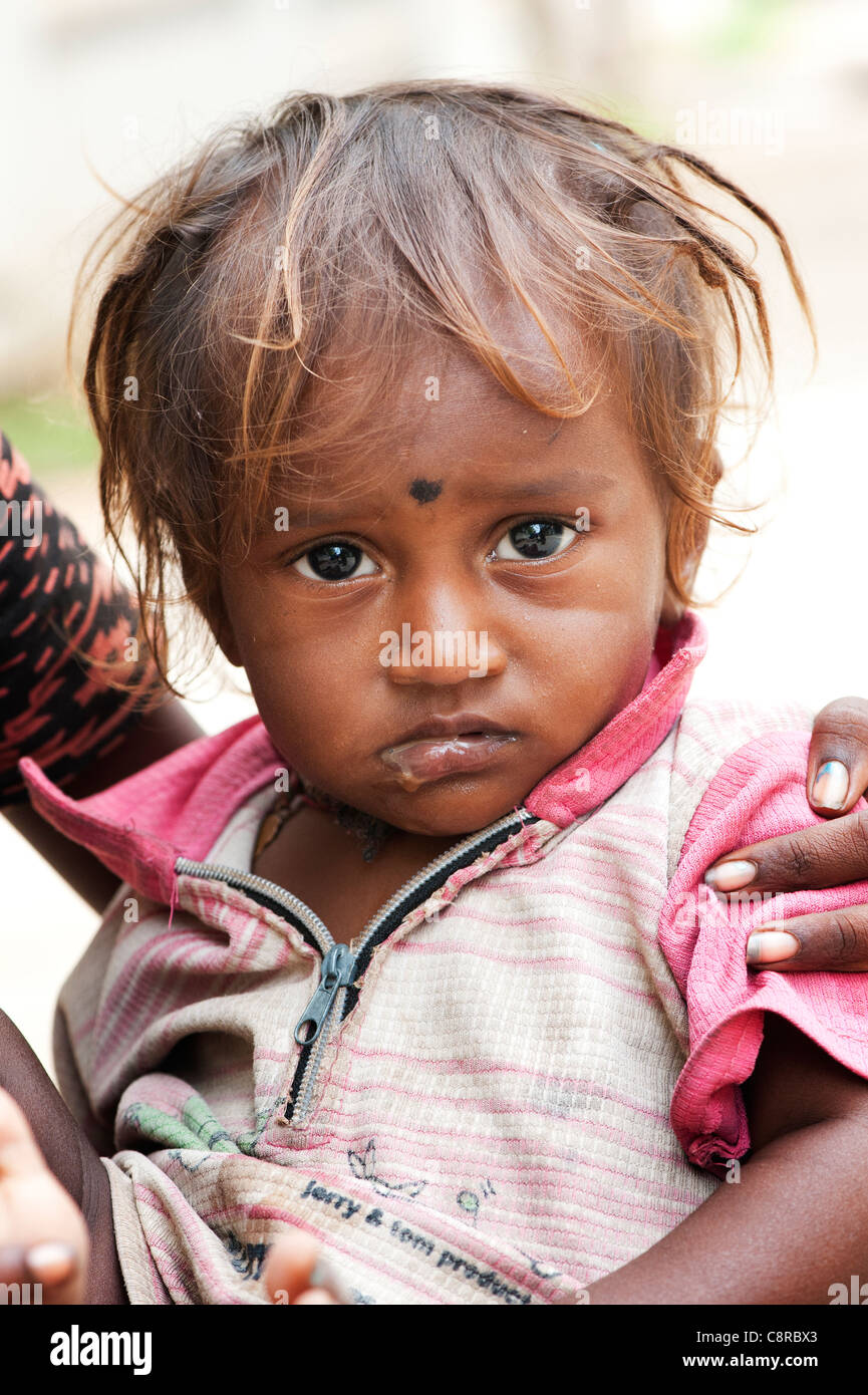 Unhappy poor lower caste Indian street baby boy Stock Photo