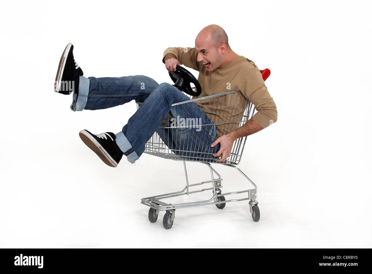 Man racing a shopping trolley Stock Photo Alamy