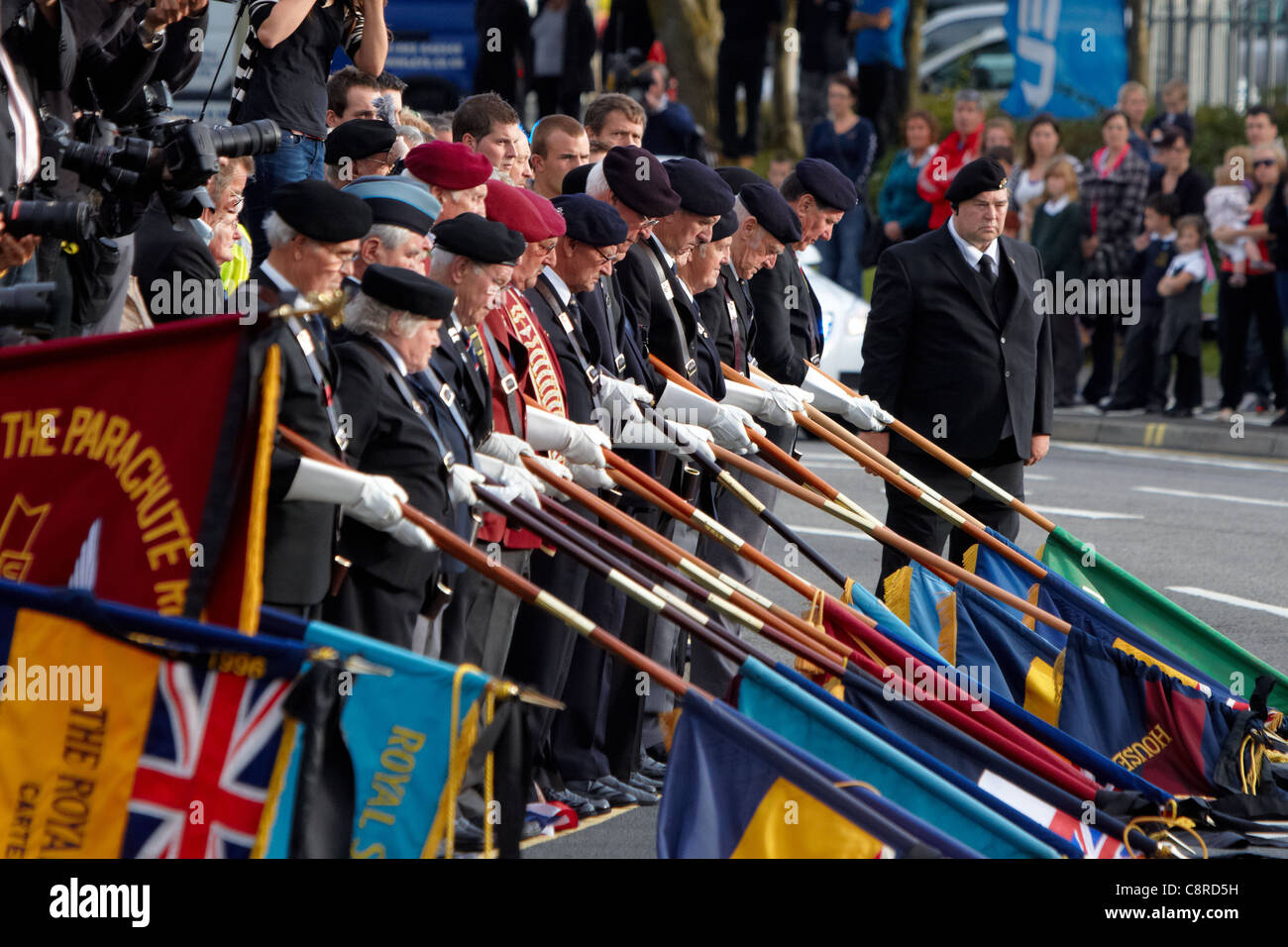 Standard bearers lower their flags as the cortege passes in Carterton