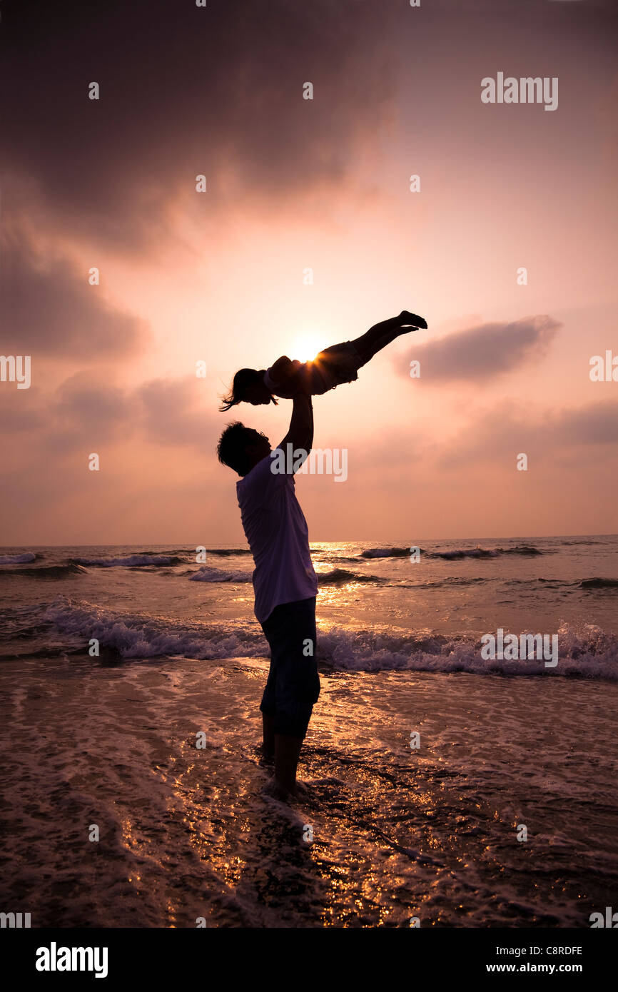 the silhouette of happy family on the beach Stock Photo