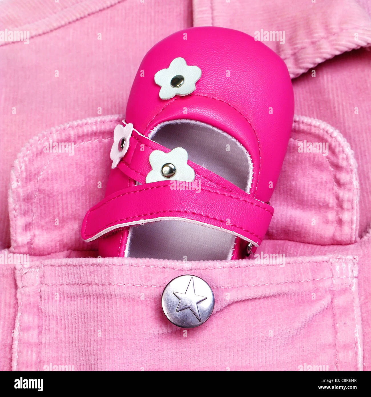 pink baby shoe in a pocket Stock Photo Alamy