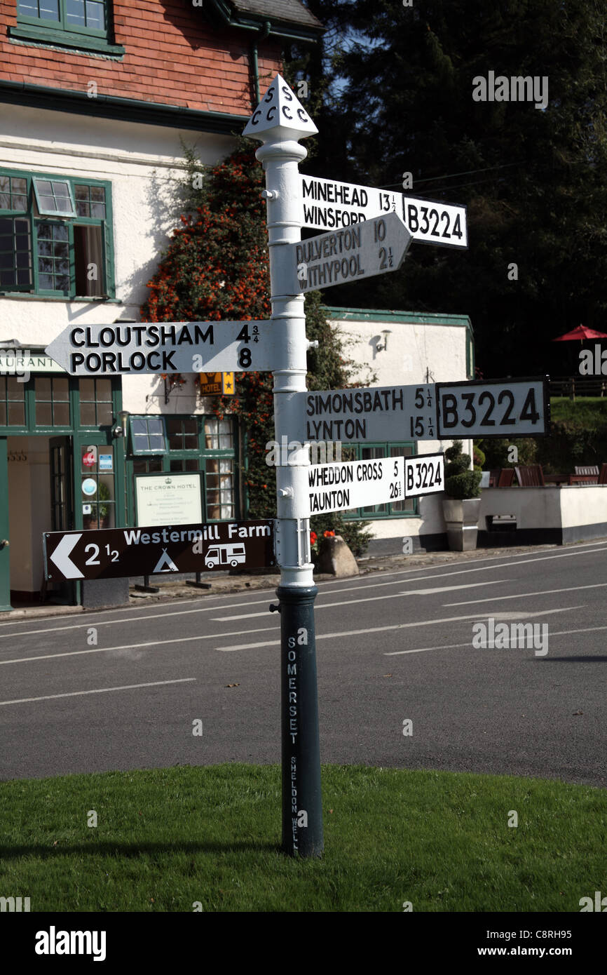 Old Fashioned Direction Signpost outside The Crown Hotel, Exford, Somerset, England Stock Photo