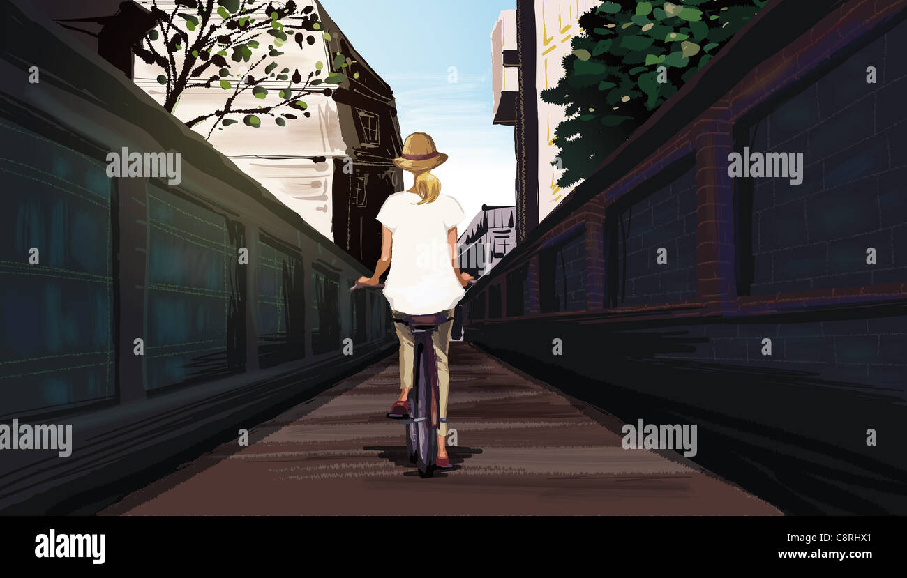 Rear view of woman riding bicycle Stock Photo - Alamy
