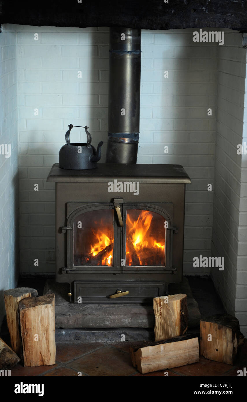 A Solid Fuel Wood Burning Stove Heating A Home Uk Stock Photo