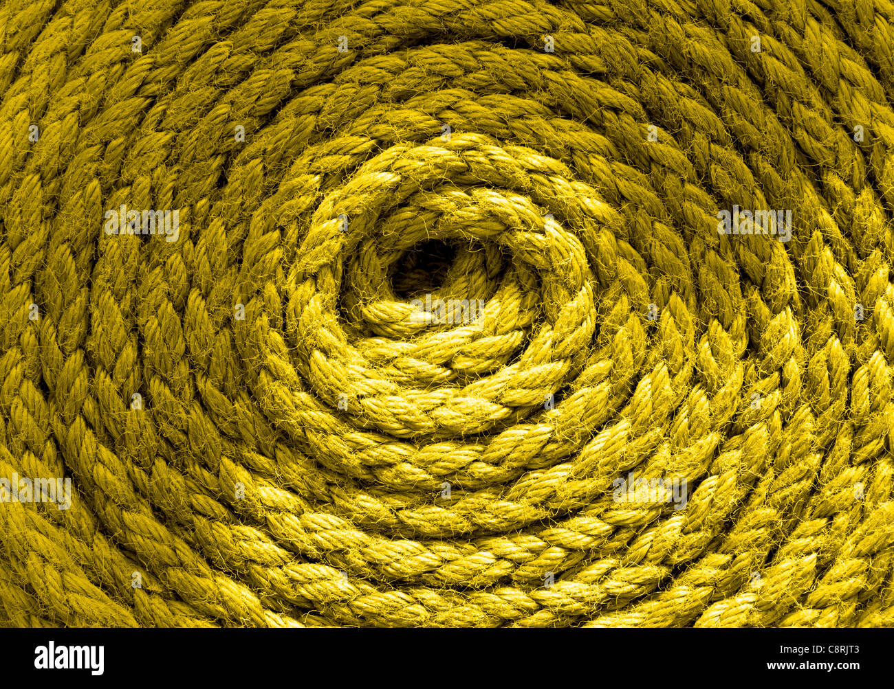 Heavy duty yellow coiled ships rope Stock Photo - Alamy