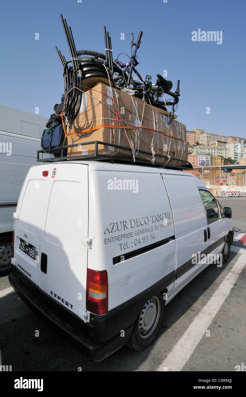 Europe, Italy, Genova. Overloaded Peugeot minivan in Genova harbour waiting  to board the ferry from Genova to Tunis in Tunisia Stock Photo - Alamy