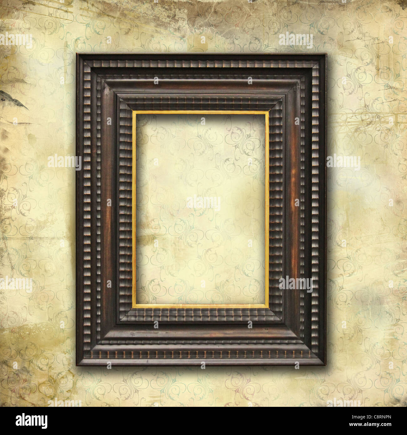 Vintage mockup, Art-deco wooden empty frame with a gold profile on grunge texture with floral stylized pattern Stock Photo