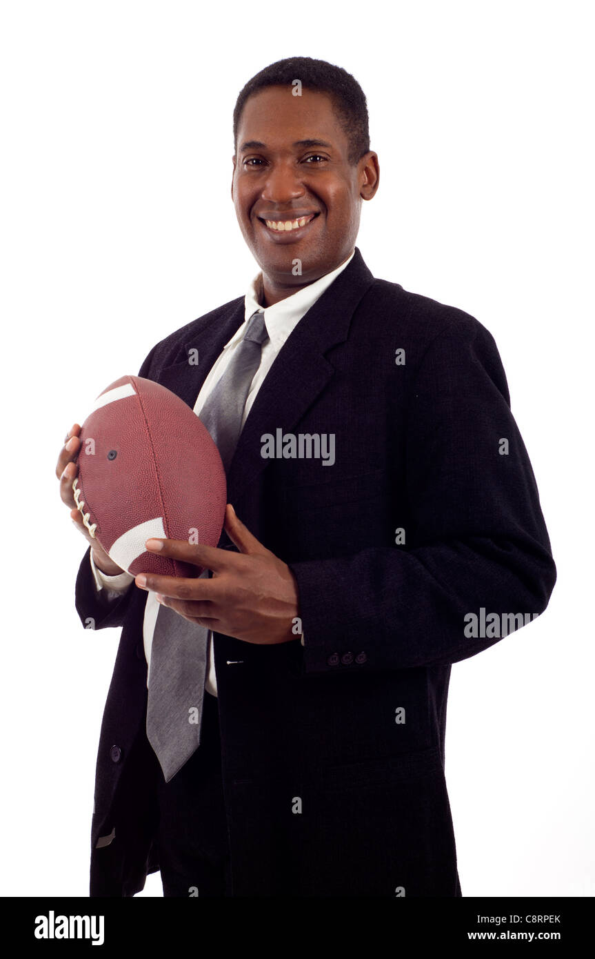 Friendly smiling black businessman holding a football isolated over white background Stock Photo