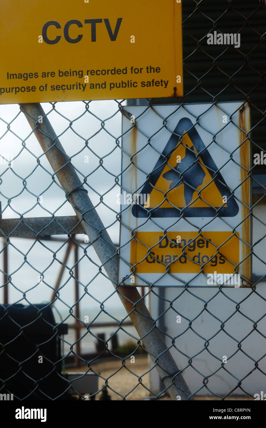 Guard dogs and CCTV warning sign. Stock Photo