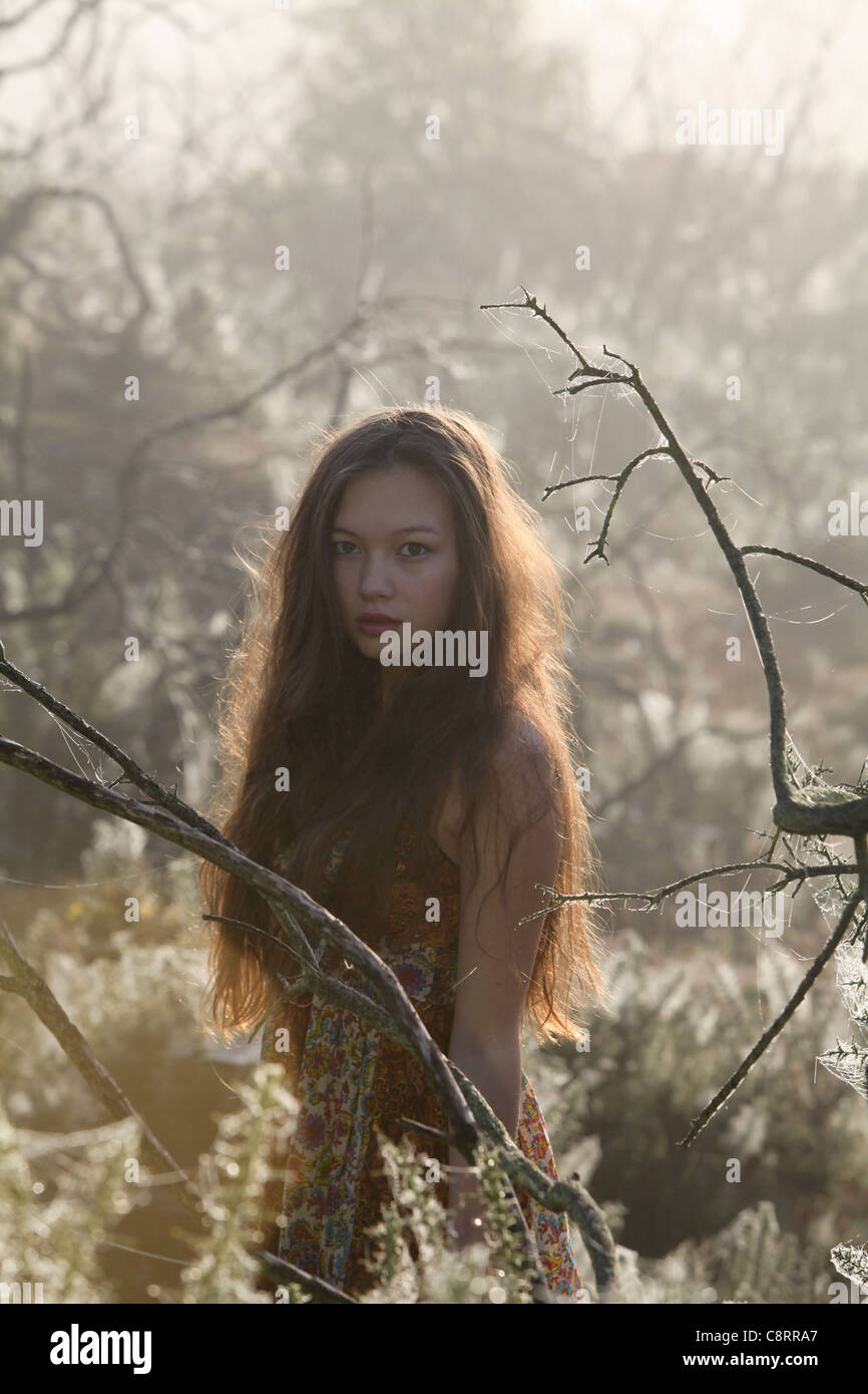 beautiful girl with long hair in a woodland mist Stock Photo